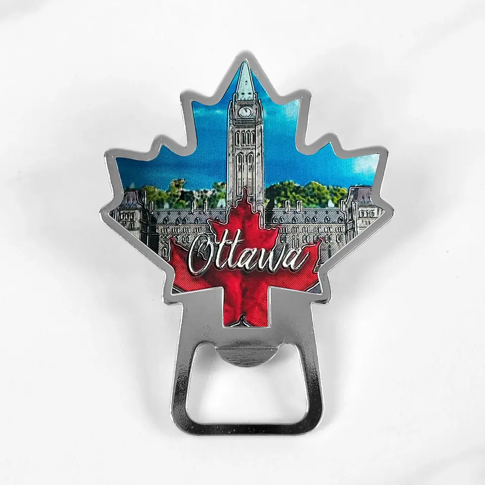 Metal magnetic bottle opener in shape of maple leaf with image of Canadian Parliament building & red maple leaf