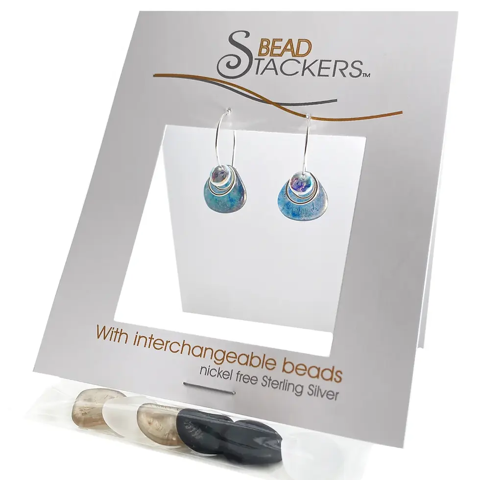 Folded white card displaying silver earring with blue bead & bag of 4 interchangeable beads stapled to card