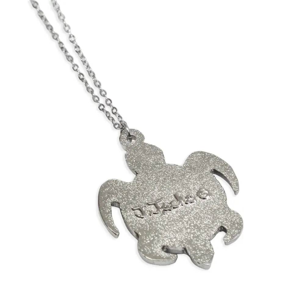 Thumbnail: Back of Medicine Turtle pendant by James Jacko showing engraved signature at Quichua World Market in downtown Ottawa.