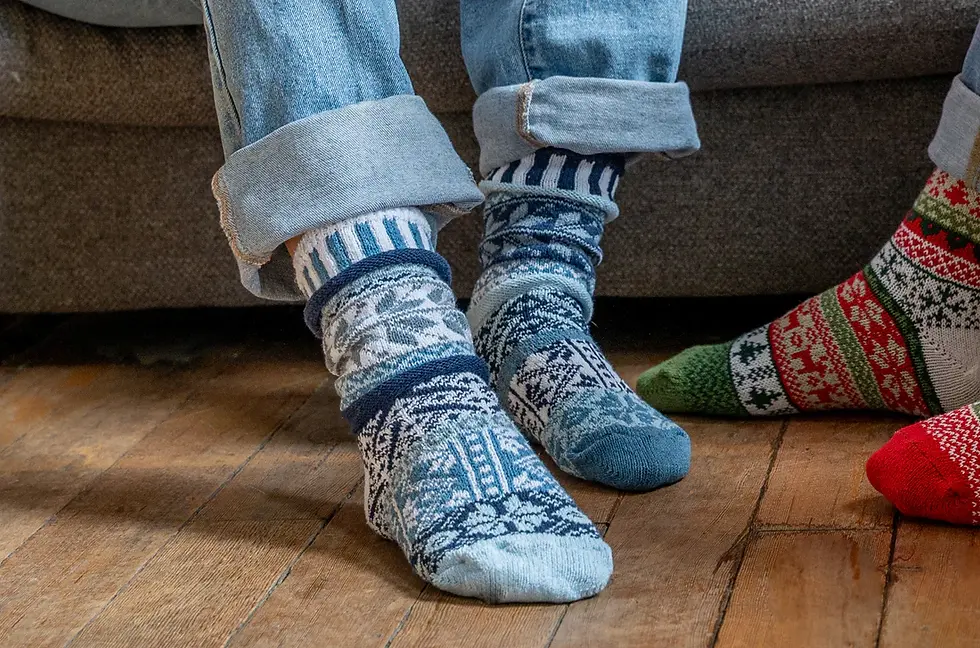 Blue, navy & white snowflake pattern socks on model