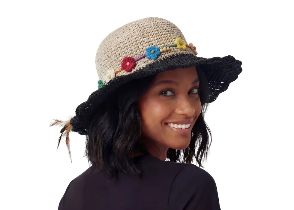 Model in sun hat with natural hemp colour crown & black brim with hatband of multi-colour flowers