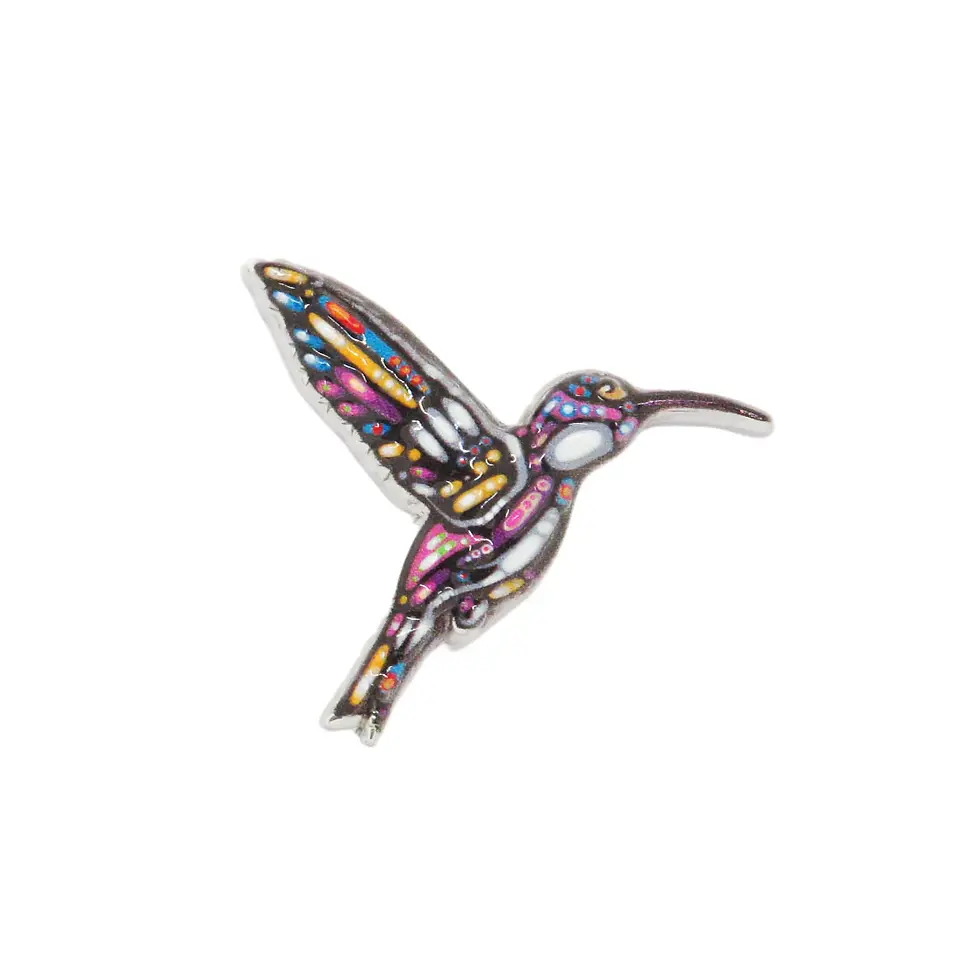 Shiny metal pin in shape of artist John Rombough's 'Hummingbird'