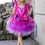 Thumbnail: Front view of little girl outside wearing hot pink & purple fancy tutu dress with flowers at waistband