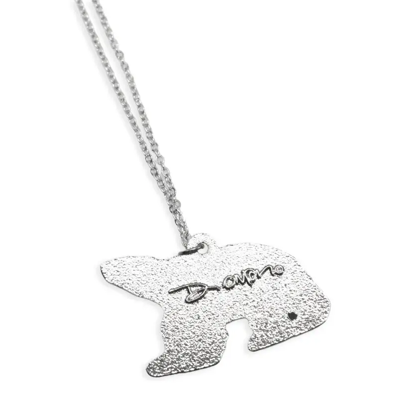 Thumbnail: Back of Spring Bear pendant by Dawn Oman showing engraved signature at Quichua World Market in downtown Ottawa.