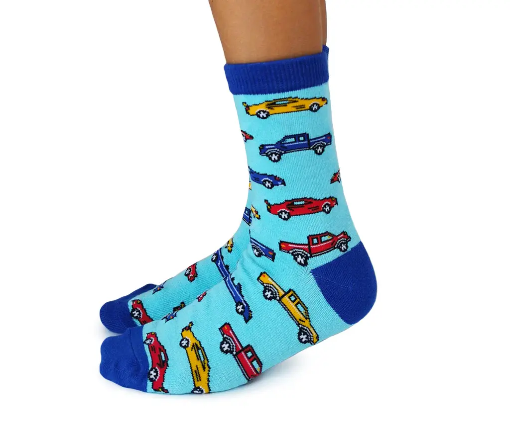 Side view of blue & turquoise pair of socks with colorful cars print