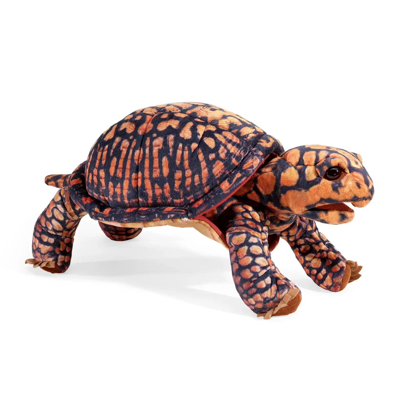 Side view of the box turtle puppet showing its movable legs and textured exterior at Tickled Pink Ottawa.