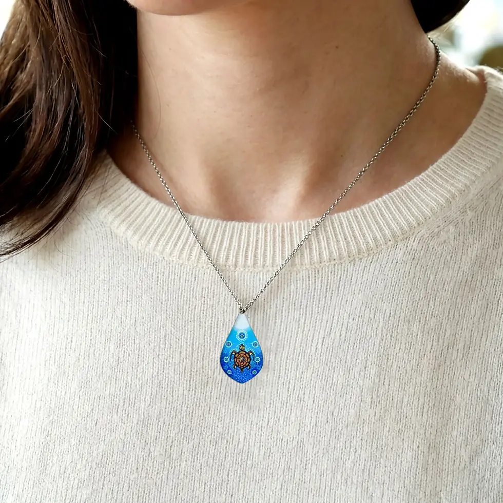 Model wearing the Medicine Turtle necklace by James Jacko on neckline at Quichua World Market in downtown Ottawa.