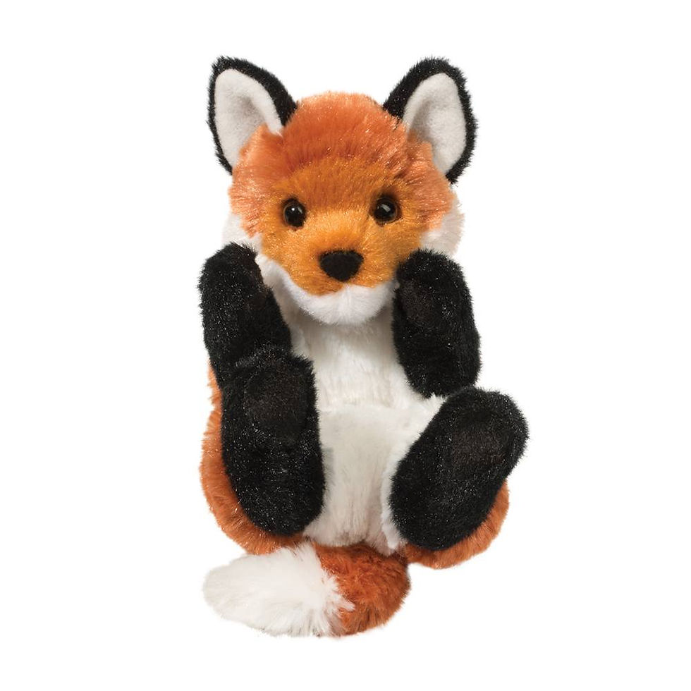 Small rust, black & white plush toy fox in curled up position