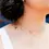 Thumbnail: Model's head & shoulders with chain of 4 flower tattoos around one side of neck