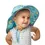 Thumbnail: Smiling baby girl wearing teal sun hat with pink & yellow jellyfish print & neck flap & adjustable strap
