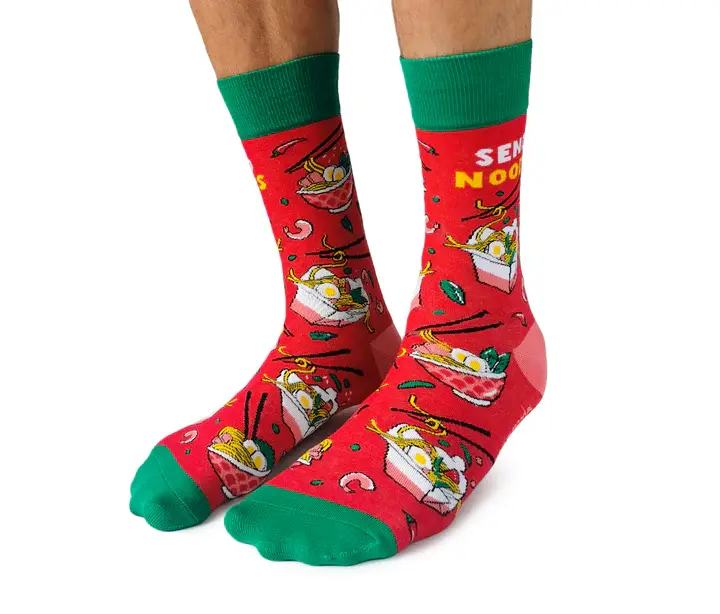 Angled front-left view of pair of red socks with print of overflowing take-out containers, text, "Send Noods""