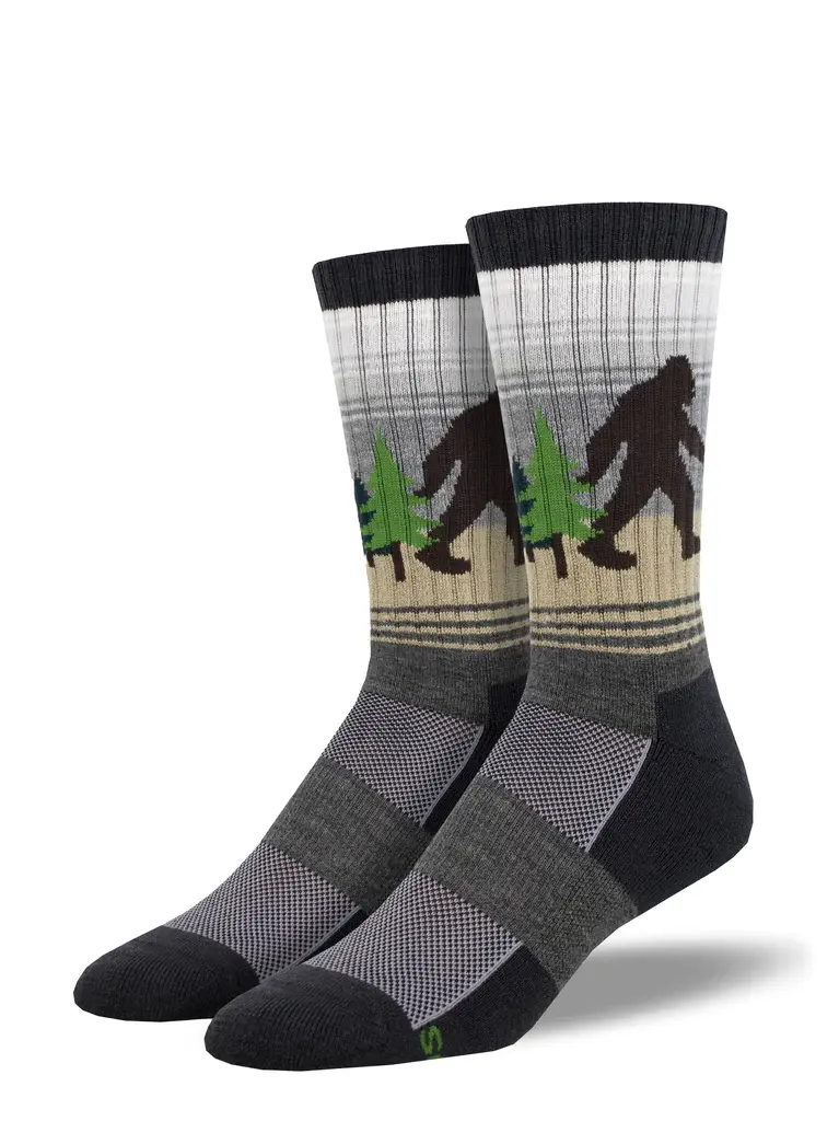 Black, gray & tan socks with image of black sasquatch carrying green fir tree