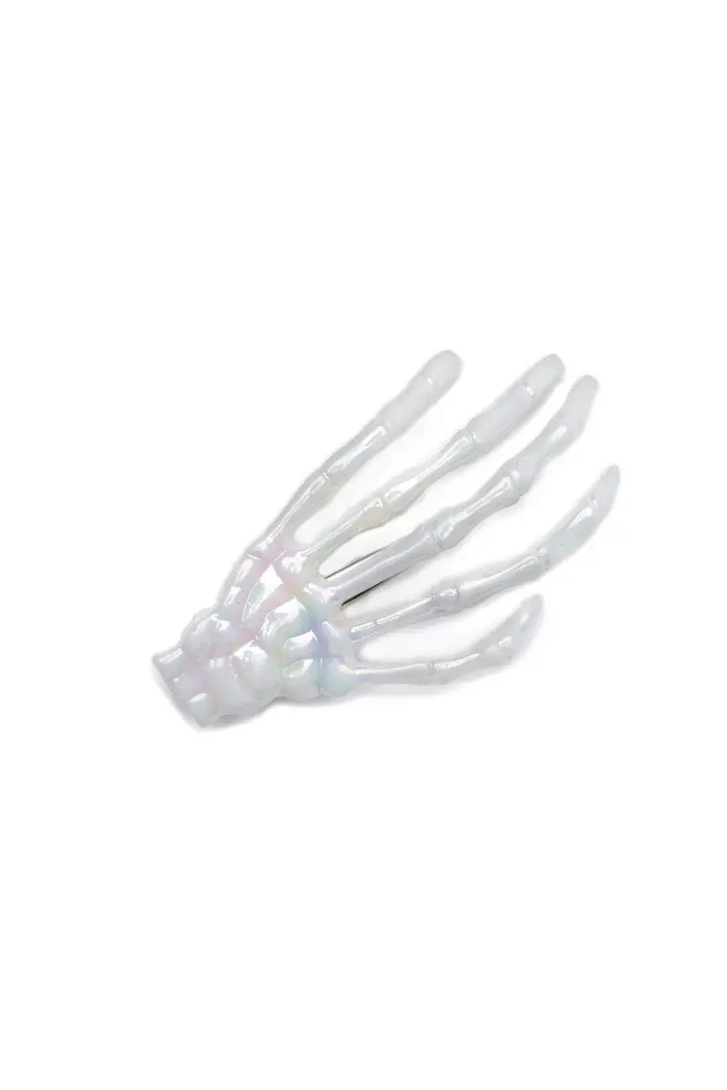 White hair clip shaped like a skeleton hand