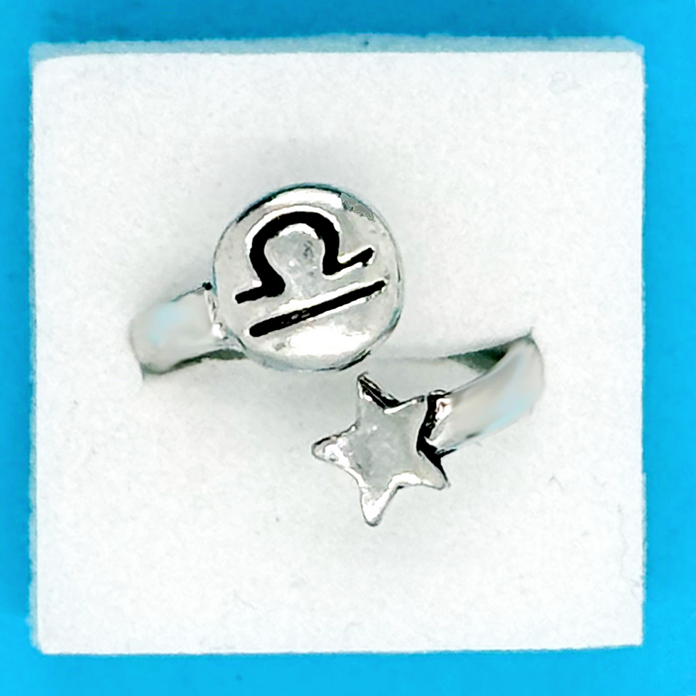 Basic Spirit pewter zodiac wrap ring featuring a stamped Libra symbol and a small star at Tickled Pink.