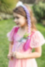 Left view of model wearing blue, purple & pink ombre hair braid with cluster of seashells in tulle ruffle