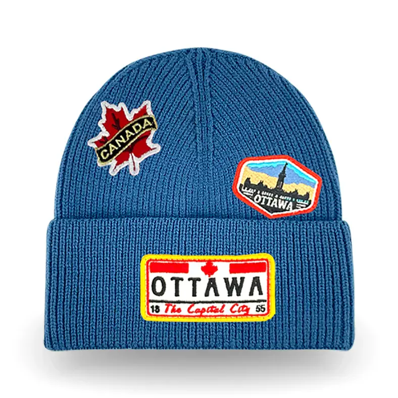 Blue knitted cuffed toque with Ottawa patches stitched on