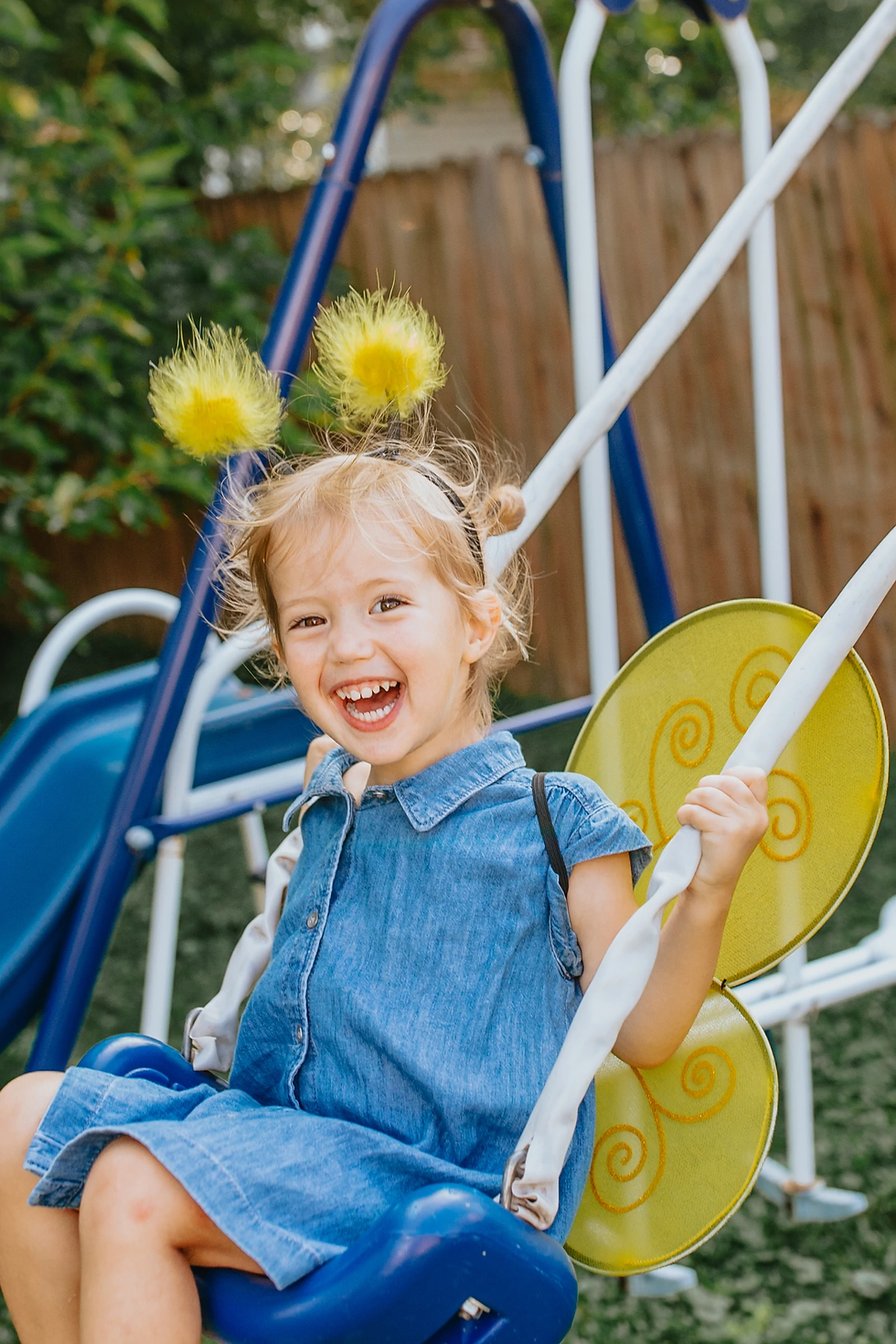 Thumbnail: Laughing little girl on swing set wearing yellow & black bumble bee wings & fluffy yellow antenna headband set