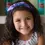 Thumbnail: Smiling little girl wearing iridescent purple & teal fabric headband with bow