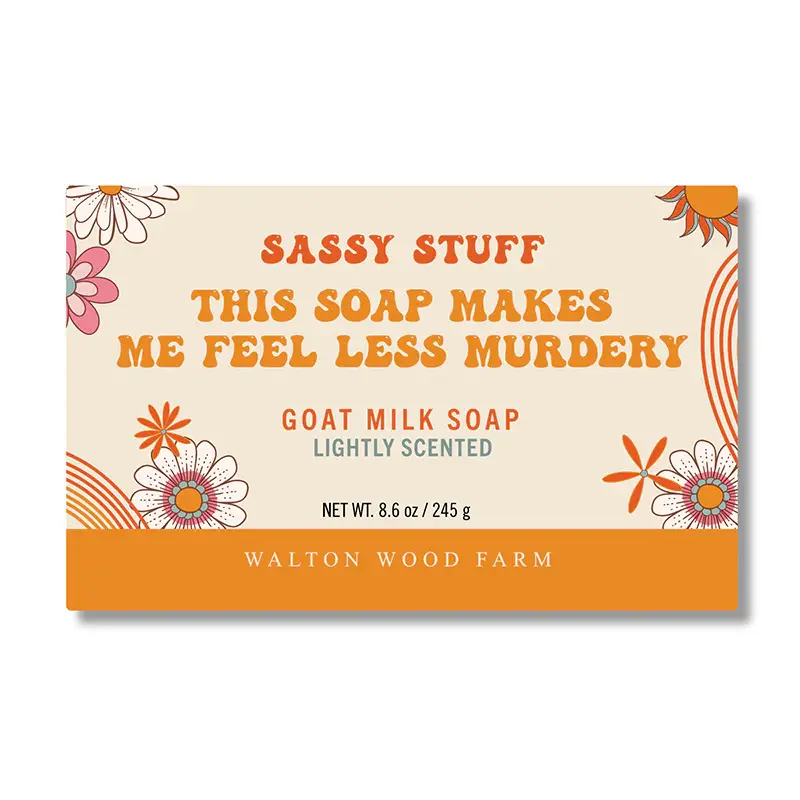 Orange & yellow paper wrapped bar soap labelled This Soap Makes Me Fell Less Murdery bar soap