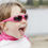 Thumbnail: Child wearing glossy pink kid's sunglasses