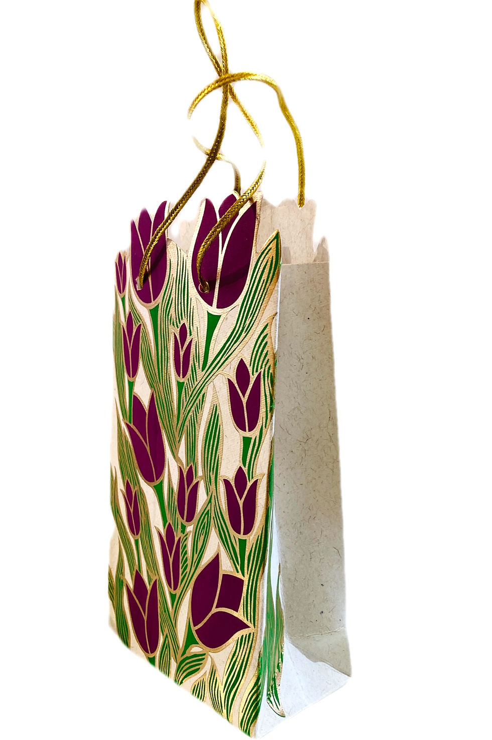 Side view of rectangular paper gift bag with gold string handles, printed with purple tulips & green leaves