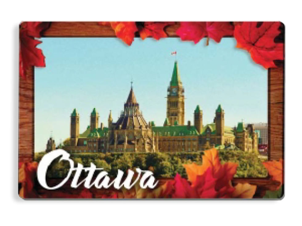 A rectangular souvenir magnet of Ottawa Parliament Hill framed by autumn maple leaves at Tickled Pink.