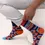 Thumbnail: Model wearing navy, blue, red & orange geometric print socks, text, 'Funcle - the Fun Uncle'