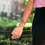 Thumbnail: Model's arm wearing green T-rex dinosaur tattoo