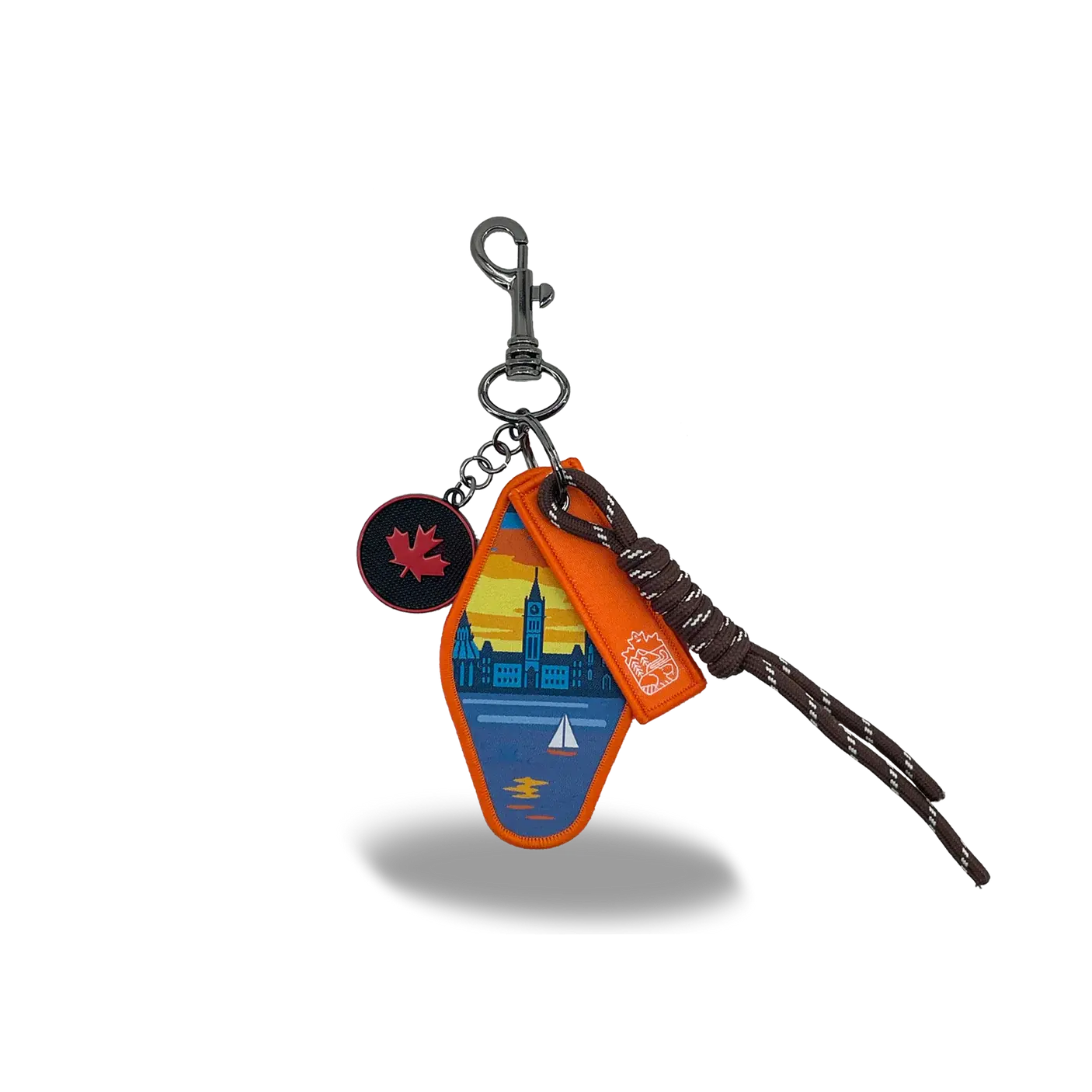An embroidered retro Ottawa motel keychain displaying a sunset Parliament skyline and a maple leaf charm at Tickled Pink.