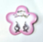 Pink & white flower shaped card holding pair of silver coloured earrings in shape of heart with iridescent crystals