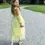 Thumbnail: Back view of little girl wearing yellow princess gown with velvet bodice & long tulle skirt