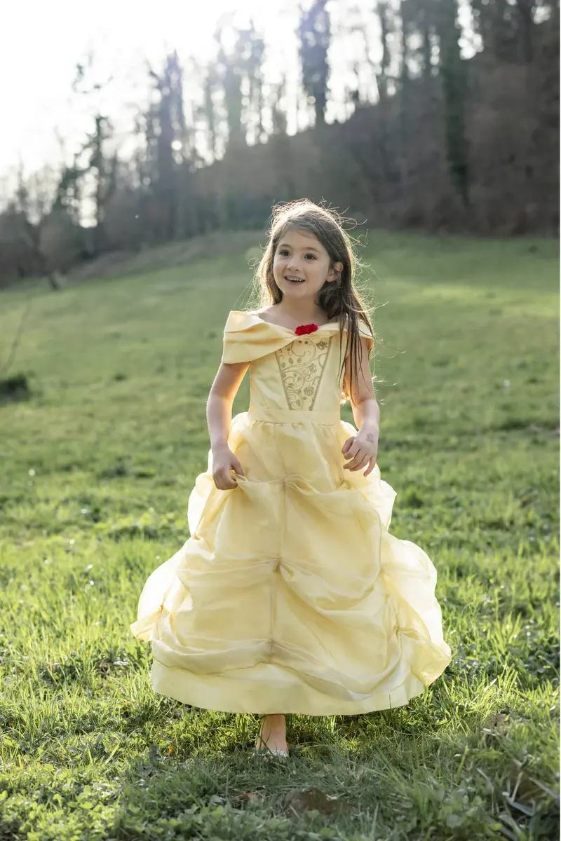 Little girl wearing long yellow Beauty princess dress with full ruched hoop skirt & off the shoulder sleeves
