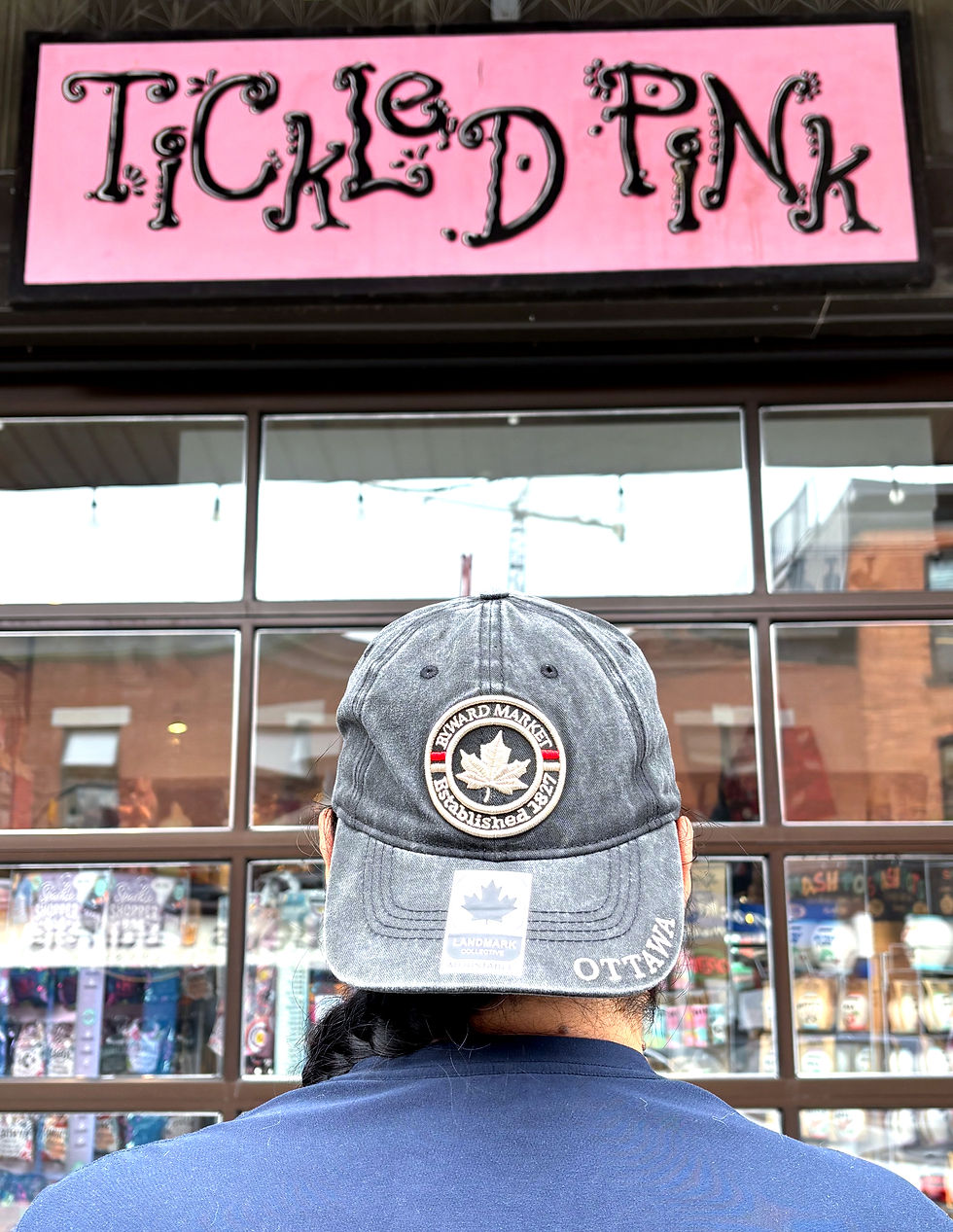 Thumbnail: Lifestyle shot of black Byward Market baseball cap in front of Tickled Pink Ottawa.