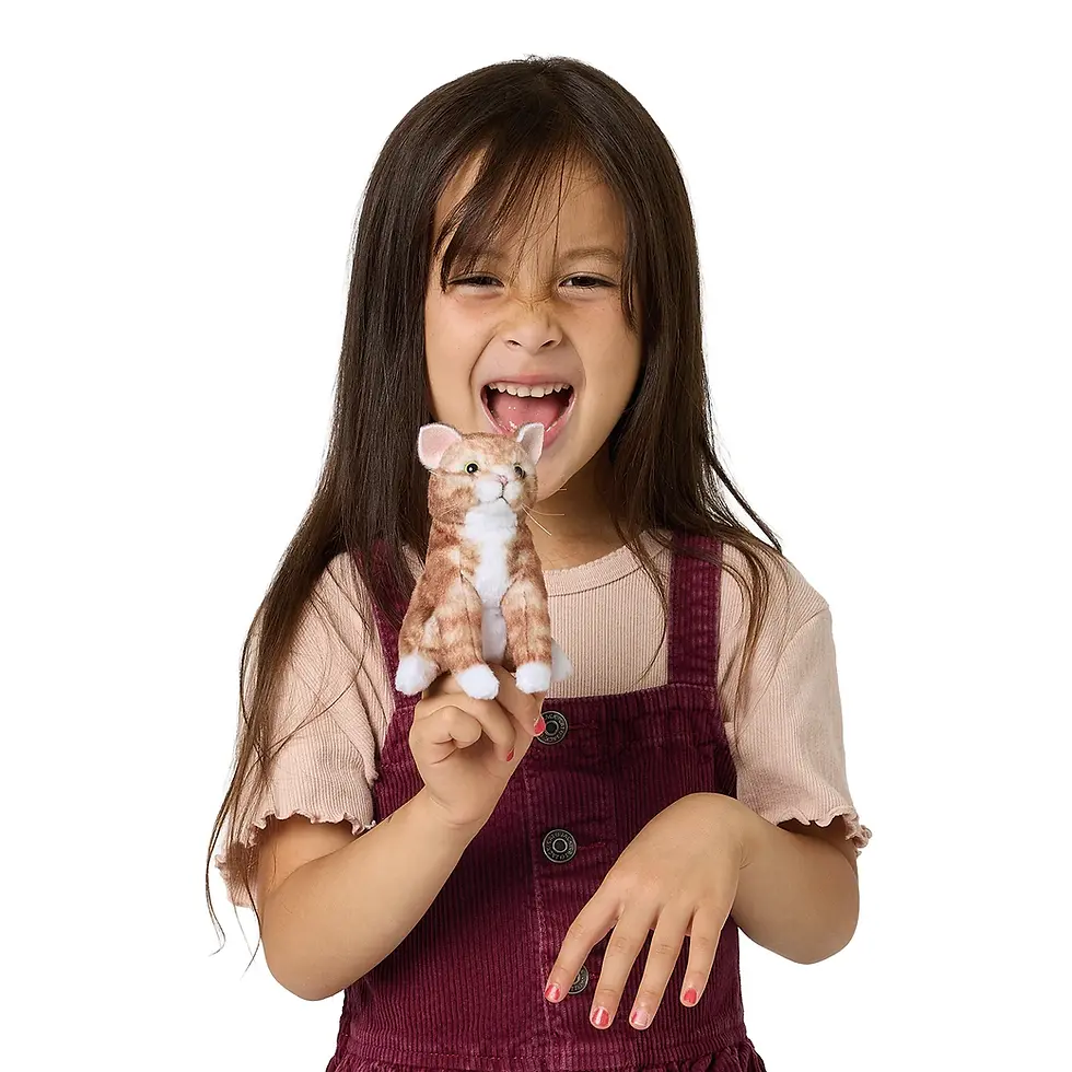 Model playing with the mini orange tabby finger puppet to show its scale and cute face at Tickled Pink Ottawa.