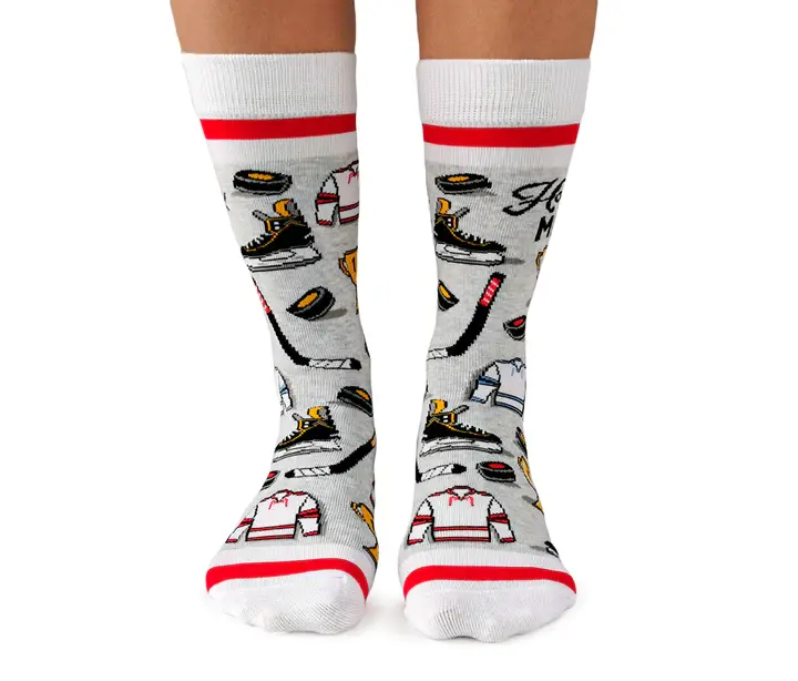 Front view of pair of gray & white socks with red stripes & print of all things hockey, text, "Hockey Mom"