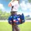 Thumbnail: Model holding long round 2 handled zippered travel bag printed with artist Dawn Oman's painting, 'Sky Watchers'
