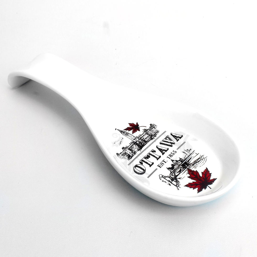 White spoon rest with black line drawings of Ottawa icons & red maple leaves