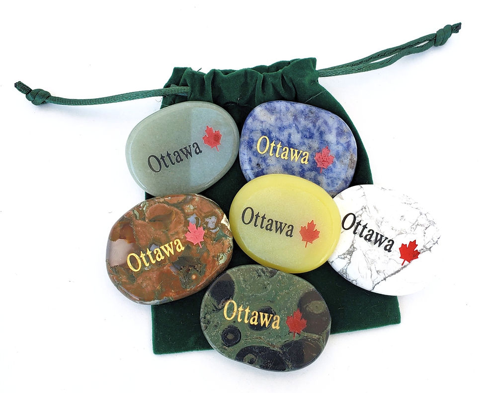 group of 6 semi precious oval shaped stones engraved with the word Ottawa and a red maple leaf, resting on a green pouch