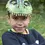 Thumbnail: Close up of child with T-Rex mask pushed up on forehead