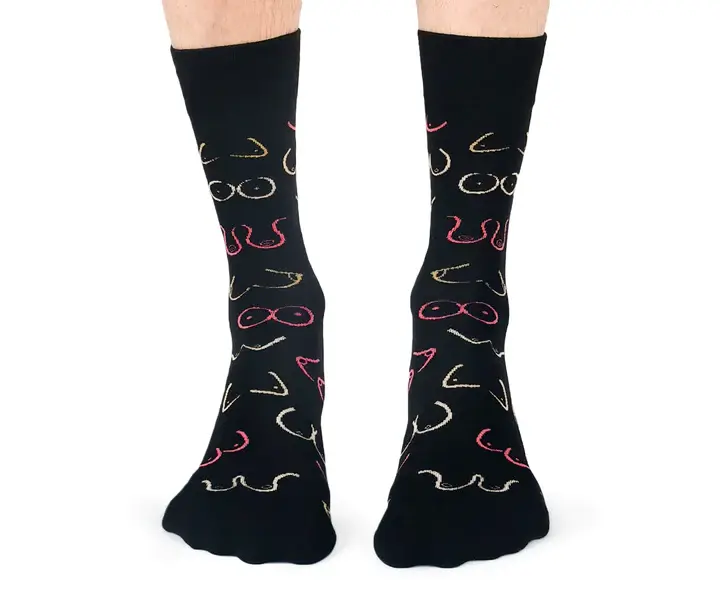 Front view of pair of black socks with print of wavy lines representing pairs of breasts in pink, yellow & white