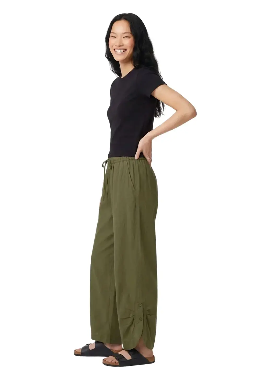 Thumbnail: Side view of model in solid olive drawstring waist pants with buttoned gathers at cuffs