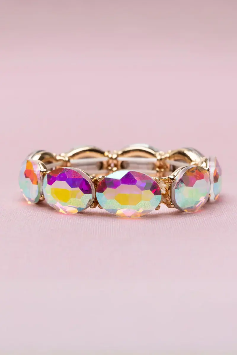 Stretchy link bracelet with large rectangular iridescent crystals in gold colored metal setting
