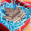 Thumbnail: Top view of pewter magnet shaped like a maple leaf inscribed with word 'Ottawa' in red box with blue raffia