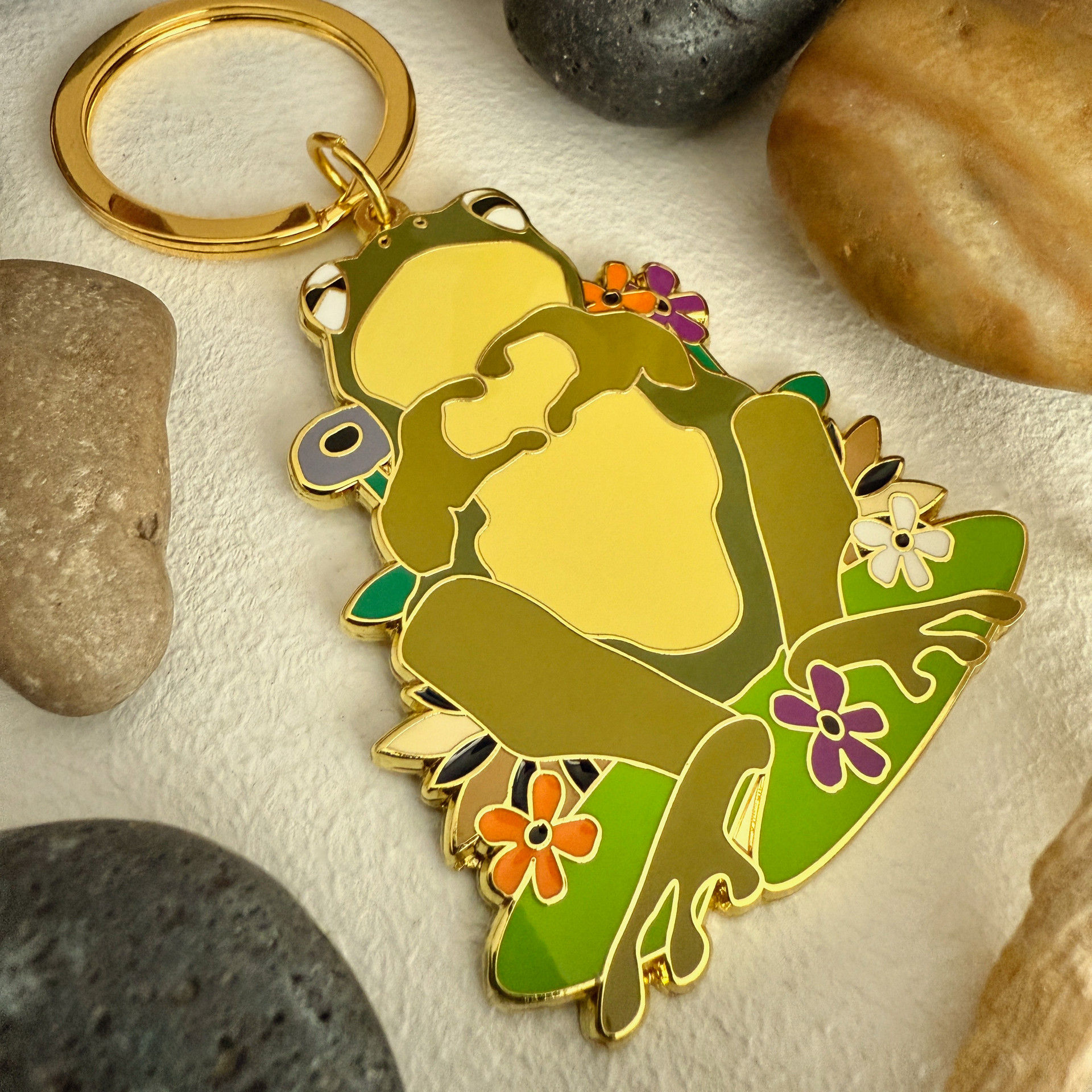 Green & yellow enamel keychain with frog making a heart with its fingers