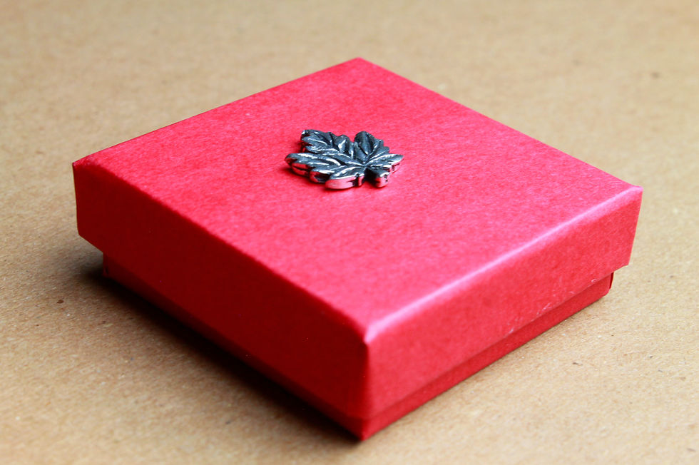 Thumbnail: Red box with small pewter maple leaf at center of lid