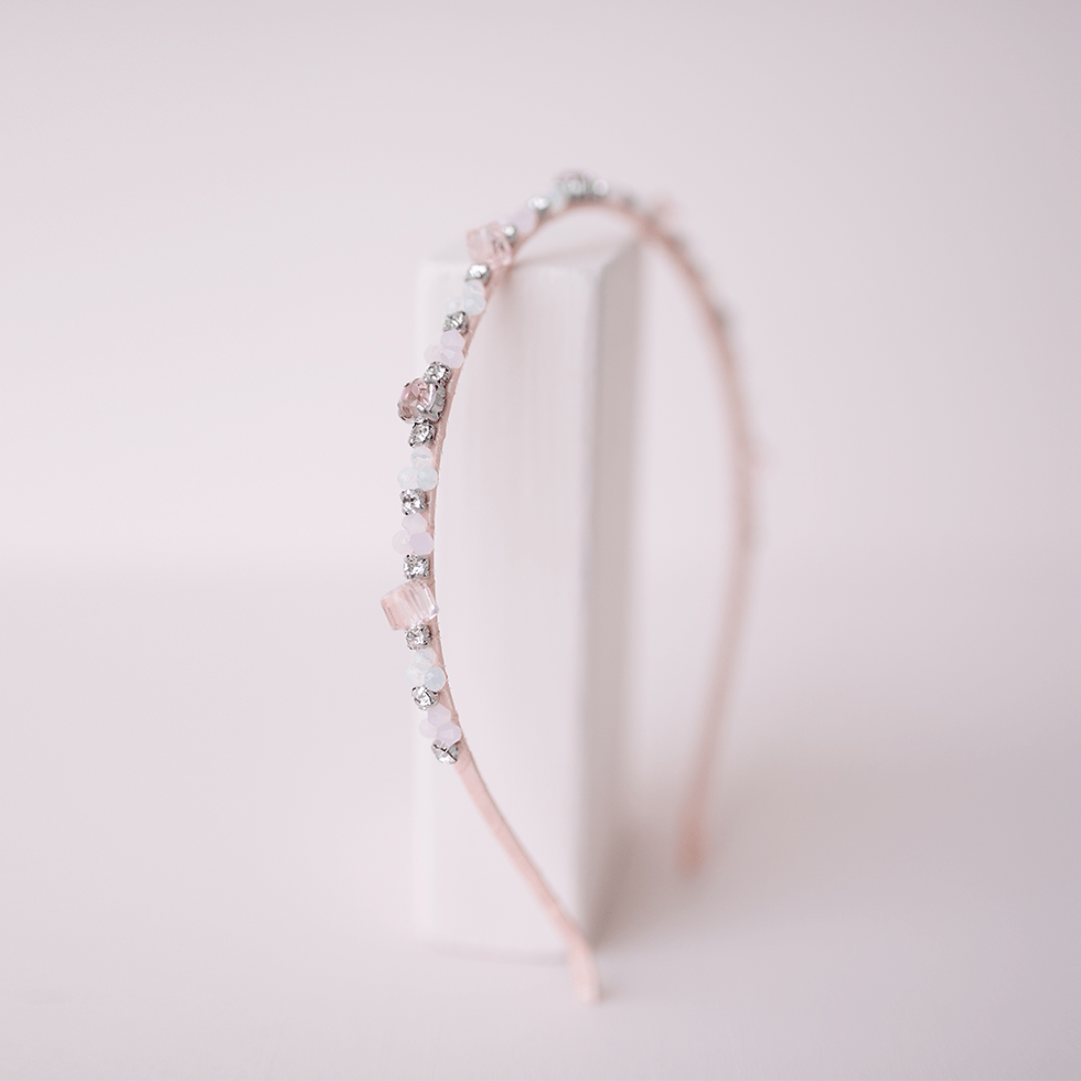 Side view of narrow pink headband with delicate rhinestones & flowers