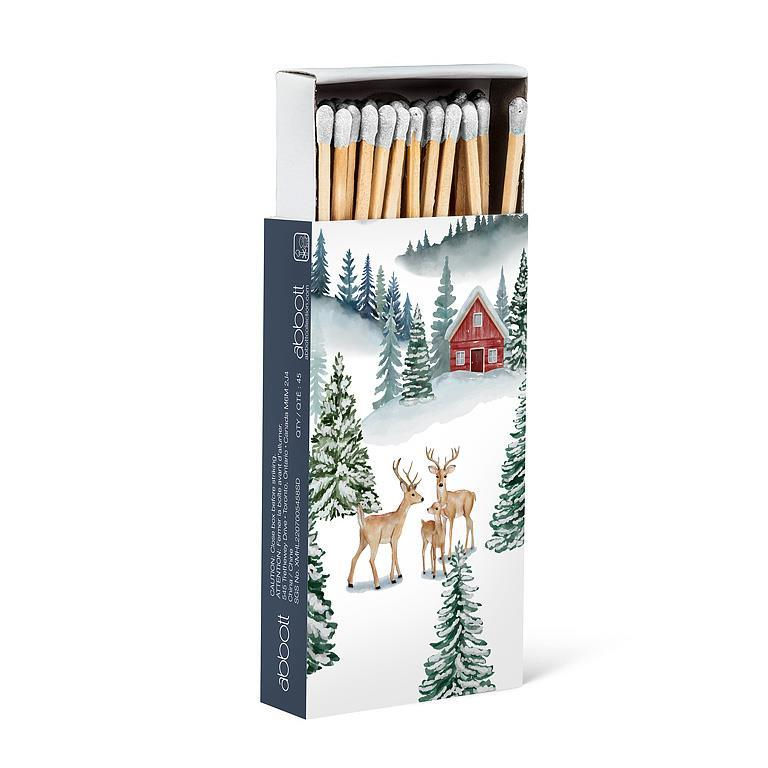 Match box of matches with scene of green fir trees on snowy mountain with deer