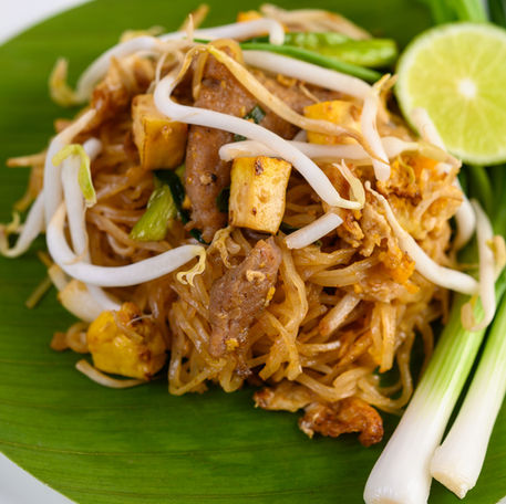 pad-thai-white-plate-with-lemon-wooden-table.jpg