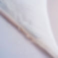 Close up of corner of white mesh banner and some drops water on it.jpg