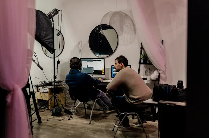 Video production session taking place inside The House Of Snob photography studio rental in Edmonton featuring professional lighting, editing workstation, and content creators